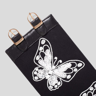 Black canvas belt with butterfly embellishments.